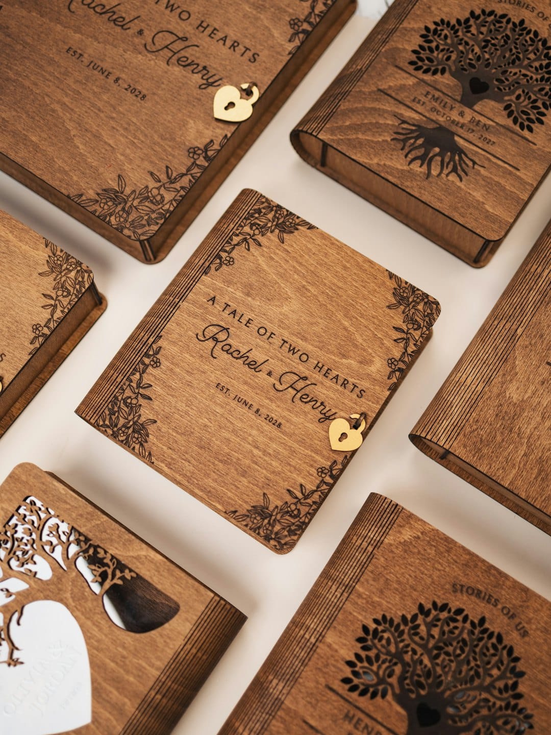 Engraved wooden boxes designed as books with personalized details.